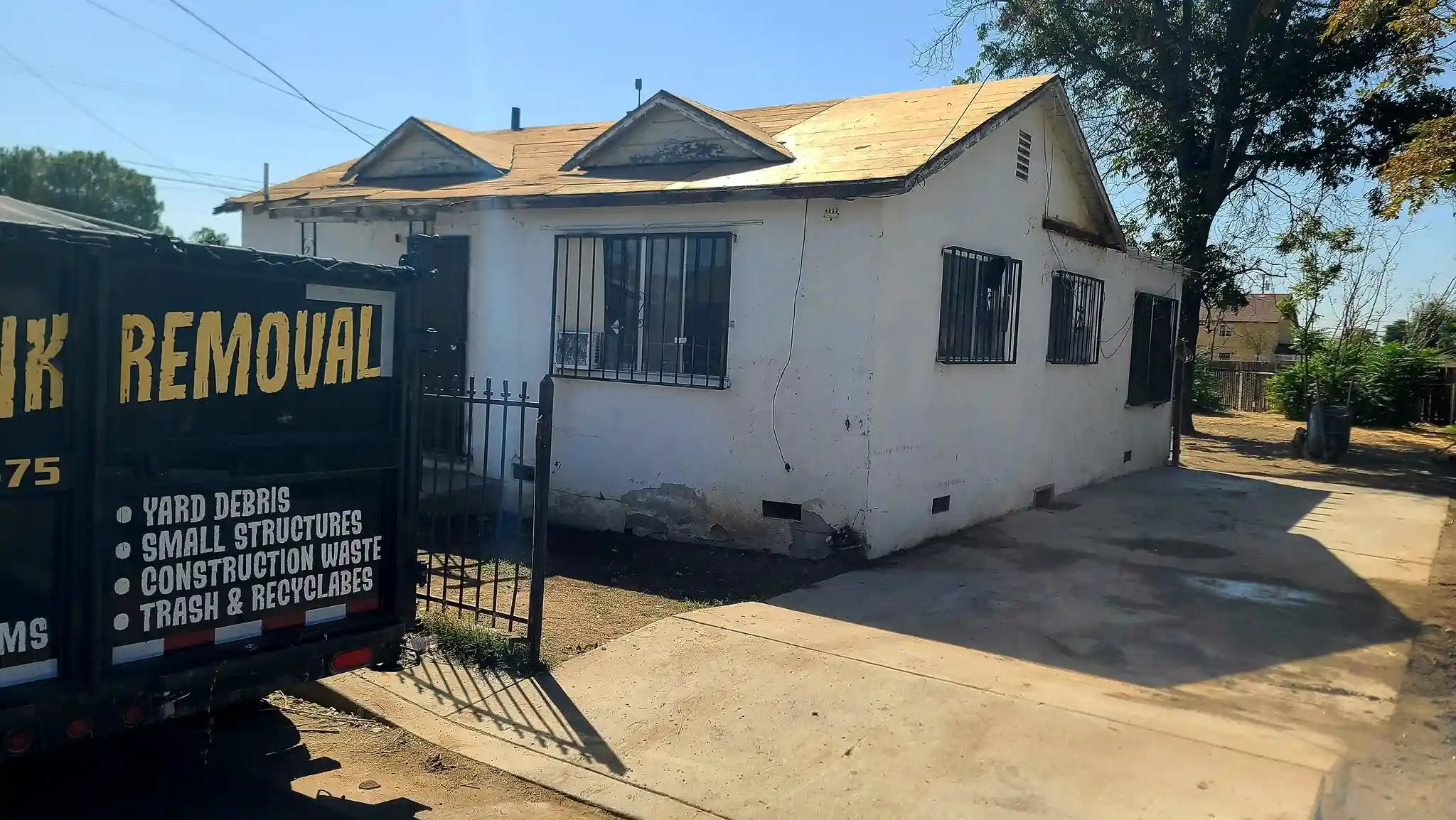 Golden Kern Junk Removal commercial hauling truck and trailer on job in Bakersfield, CA